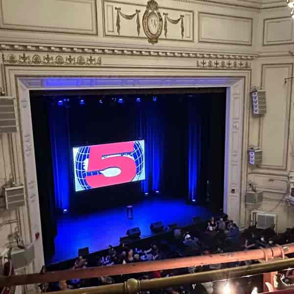 Main Hall at The Wilbur with stage, digital display, and blue lighting for events.