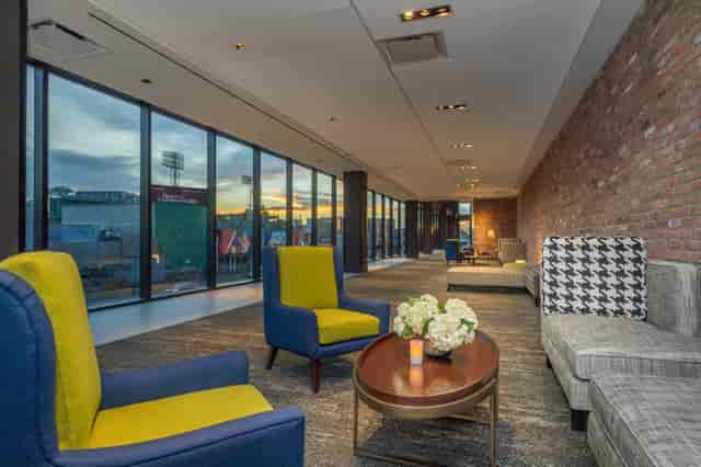 Olmsted Room at Hotel Commonwealth: modern event space with large windows and stylish seating.