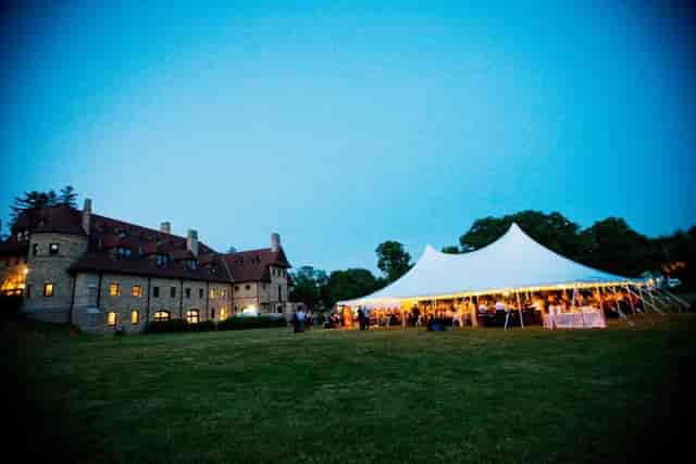 Elegant outdoor event at Larz Anderson Auto Museum with a large tent, perfect for gatherings.