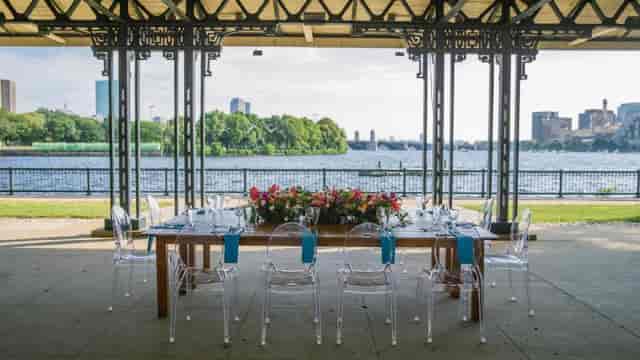 Elegant outdoor dining at Washburn Pavilion, featuring floral decor and waterfront views.