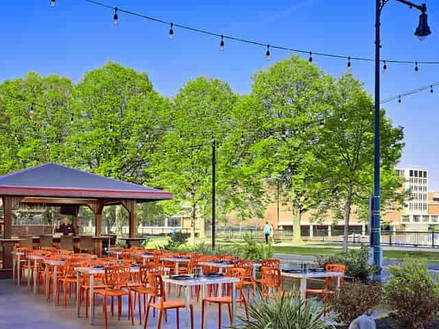 Outdoor event space at Royal Sonesta Boston with vibrant seating and lush greenery.