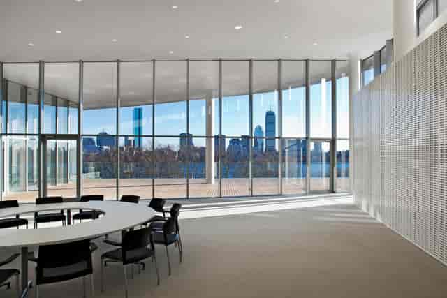 Modern meeting room at MIT Media Lab with circular table and city skyline view.