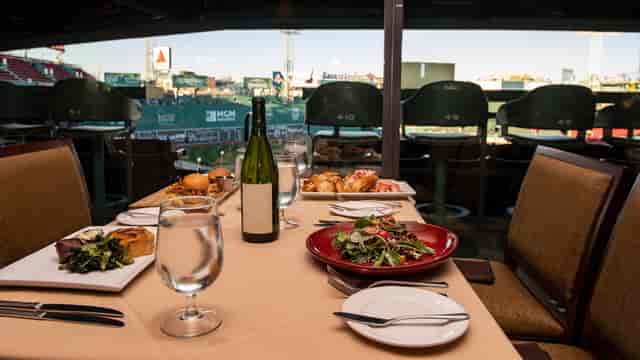 Dell Technologies Club dining table with gourmet dishes at Fenway Park for corporate events.