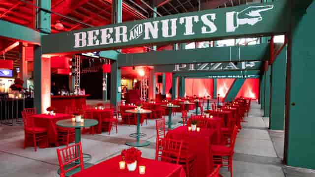 Big Concourse at Fenway Park with red tables, perfect for networking events.