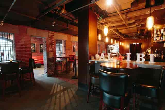 Stylish Alibi Bar & Lounge with rustic brick walls, perfect for networking events.