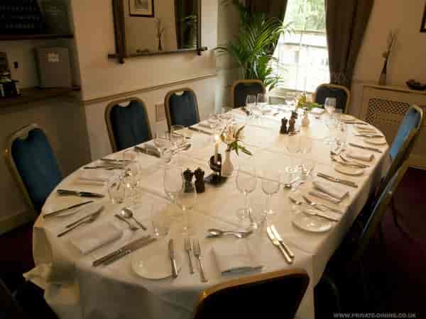 Elegant private dining room with oval table, ideal for corporate dinners and gatherings.