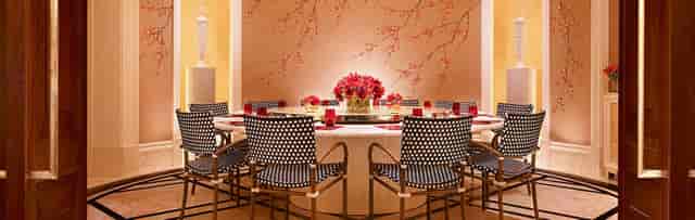 Elegant Executive Boardroom at Encore Boston Harbor with round table and floral centerpiece.