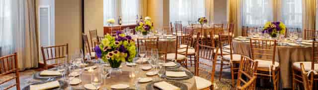 Elegant banquet room with floral centerpieces at Battery Wharf Hotel for upscale events.