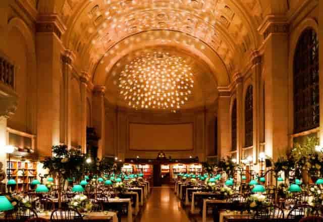 Bates Hall event space with elegant tables and lush centerpieces in Boston Public Library.
