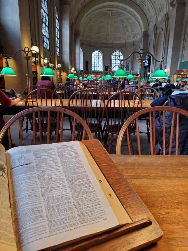 Boston Public Library's Popular Reading Room with wooden tables, ideal for workshops and meetings.
