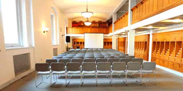 McKim Building Orientation Room: bright meeting space with gray chairs for workshops.
