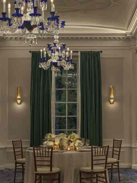 Elegant event space at Newbury Salon West, featuring green drapery and chandelier.