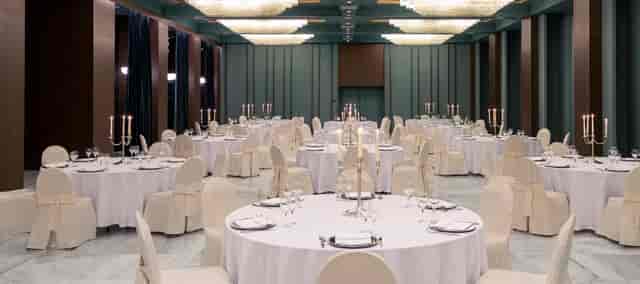 Elegant banquet hall with round tables, perfect for formal events and celebrations.