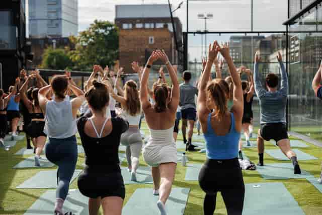 Outdoor yoga session at Padel Social Club for wellness events and team-building retreats.