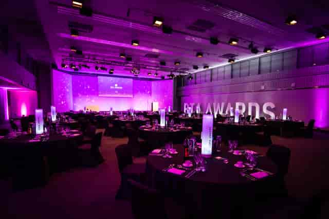 Elegant awards ceremony setup at Mountbatten, featuring round tables and purple lighting.