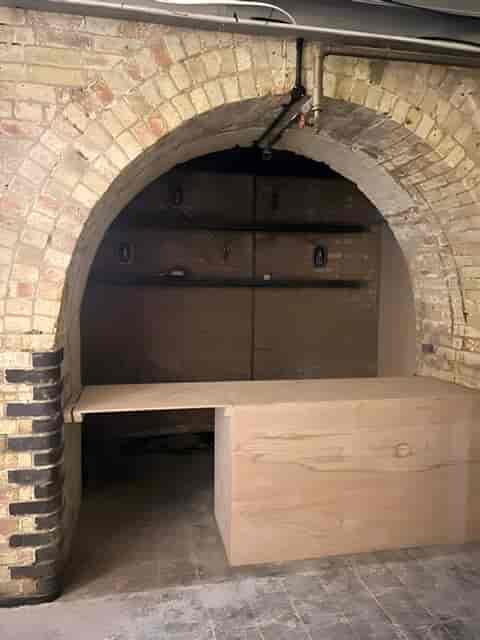 Rustic arched venue with exposed brick for intimate gatherings and unique events.