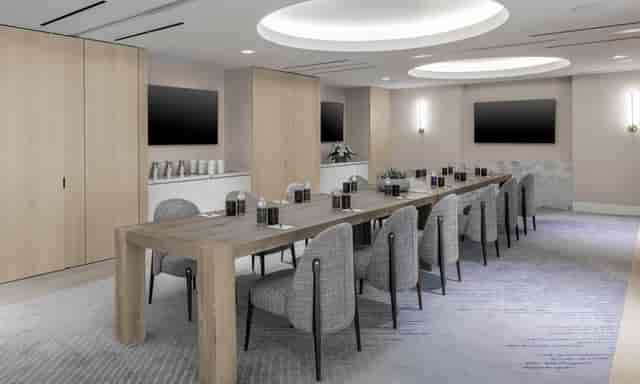 Modern meeting room in The Morrow Hotel with long table, ideal for professional gatherings.