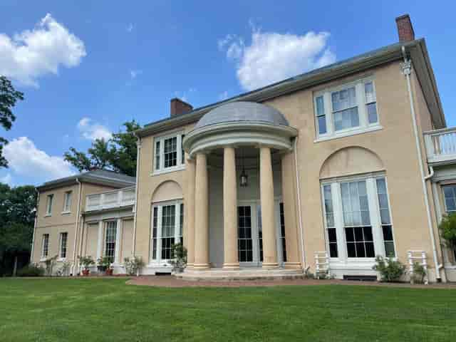 Tudor Place landmark with grand columns, ideal for upscale events and corporate retreats.