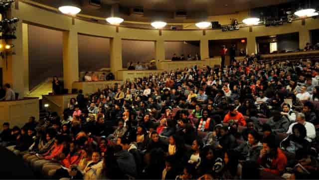 Packed auditorium at Shakespeare Theatre Company, showcasing audience engagement and networking.
