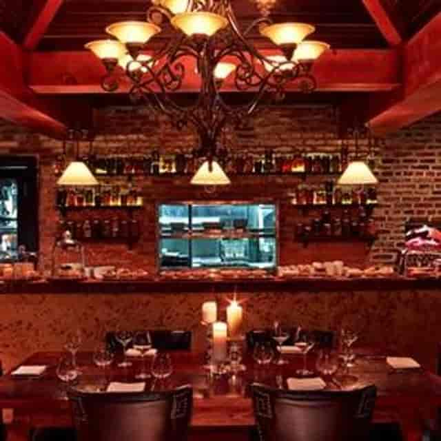 Cozy restaurant in Iron Gate with rustic brick walls, ideal for intimate events.