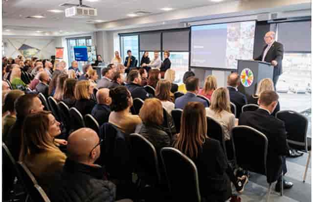 "Engaged audience at Connexin Live auditorium during a professional conference"