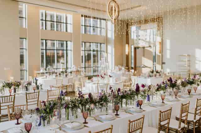 Elegant ballroom with floral centerpieces, ideal for weddings and formal events.