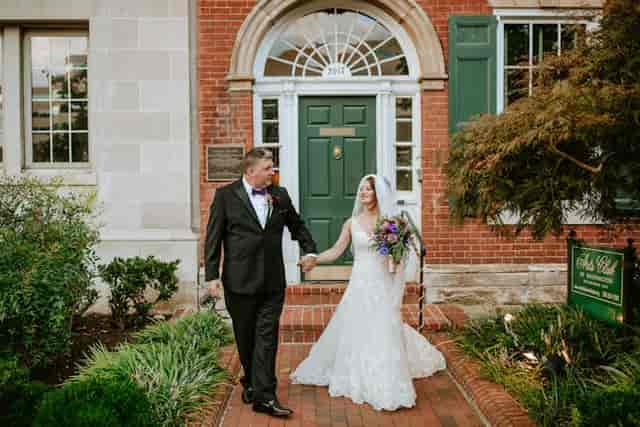 Couple exiting Arts Club of Washington courtyard, ideal for weddings and events.