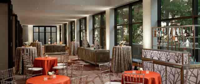 Potomac Conference Room with orange linens, ideal for networking events in DC.