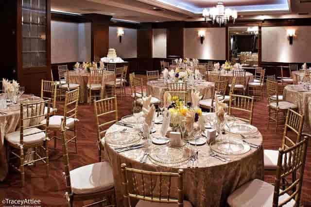 Elegant banquet hall with gold chiavari chairs for weddings and corporate events.