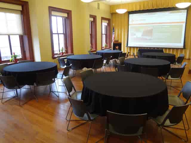 Elegant event space with round tables for a seminar at Constantino Brumidi Gallery.