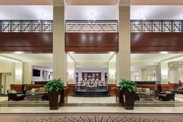 Business center lobby at Capital Hilton, spacious with modern furnishings for events and meetings.