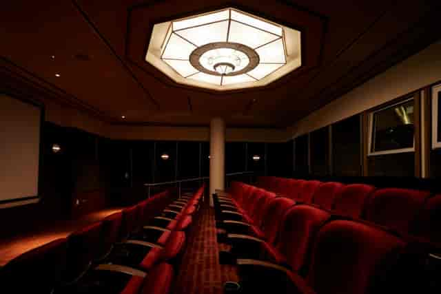 Sophisticated Eaton DC cinema with plush red seating for corporate events and presentations.