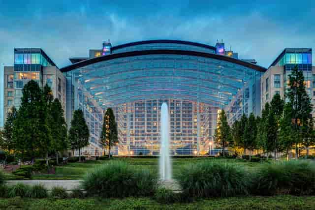 Aspire hotel atrium at Topgolf D.C., ideal for events with natural light and greenery.