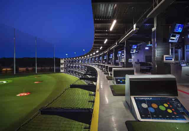 Modern golf driving range at Topgolf D.C. for corporate events and team-building activities.