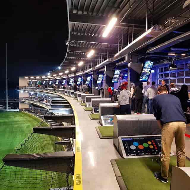 "Modern Topgolf D.C. event space with vibrant bays for corporate gatherings and team-building."