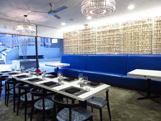 Modern dining room with blue seating, perfect for corporate events and gatherings.