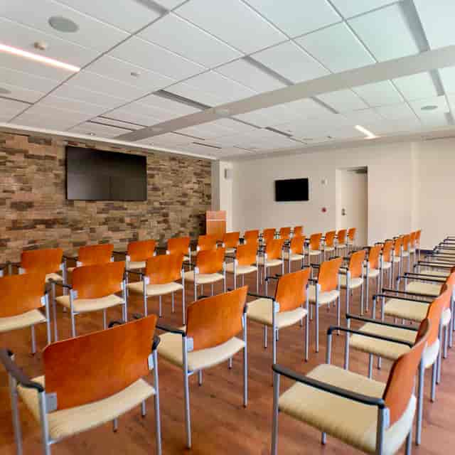 Cabinet Conference Room with stone wall, ideal for workshops and seminars.