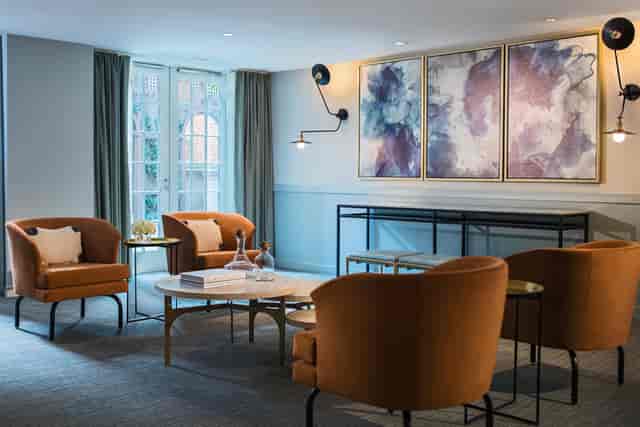 Stylish meeting space in Archer Hotel Alexandria with modern furnishings and natural light.
