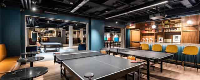 Versatile event space with ping pong tables for networking and team-building activities.