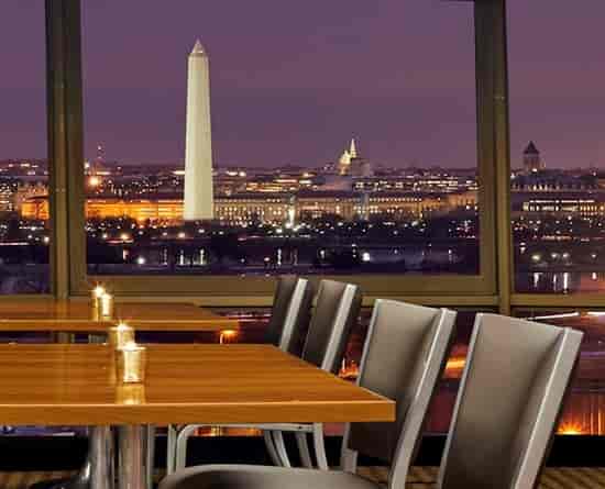 Sky Room in SPIN with elegant setup and view of Washington Monument for upscale events.