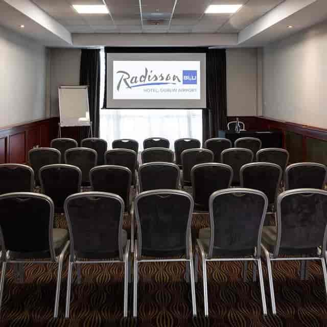 Meeting room at Radisson Blu Dublin Airport, featuring a presentation screen for corporate events.
