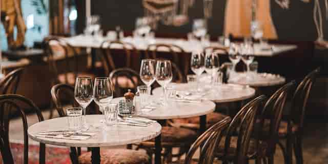 Elegant banquet hall with marble tables, perfect for upscale events and corporate meetings.