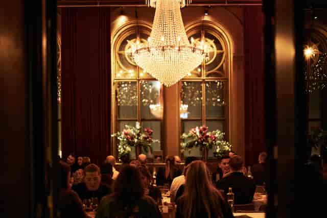 Elegant banquet hall with chandelier, perfect for corporate events and galas.