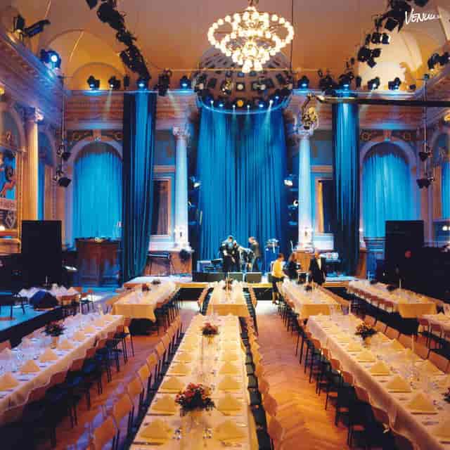 Elegant event space in Harlem, featuring long tables for corporate gala dinner.
