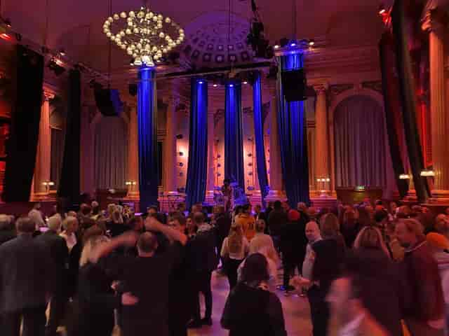 Vibrant Stora Salen event space with dramatic lighting, perfect for networking and celebrations.