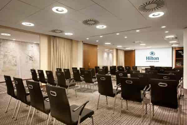 Modern meeting room at Ersta Conference with black chairs for corporate presentations.