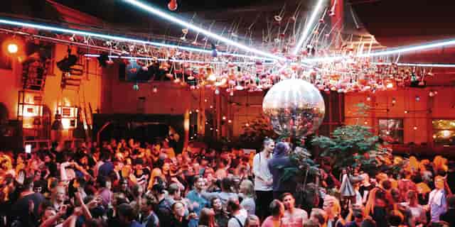 Vibrant Münchenbryggeriet event space with disco ball, ideal for social gatherings.