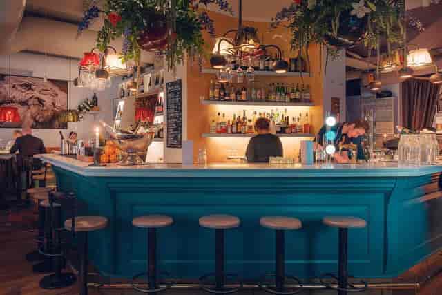 Vibrant bar area in Aubergine restaurant, perfect for networking events and social gatherings.