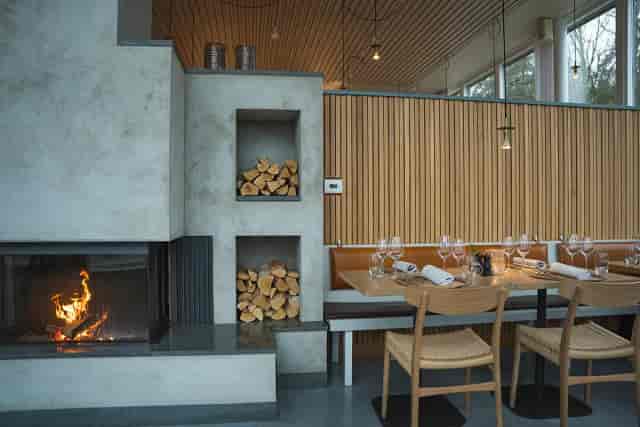 Modern banquet hall with cozy fireplace for intimate gatherings and corporate events.