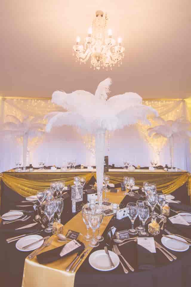 Elegant Pavilion at Quendon Hall with white feather centerpieces for upscale events.